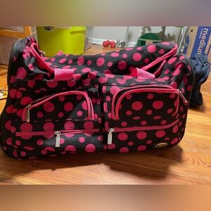 Rockland 22-inch rolling duffel bag in a black and pink dot pattern